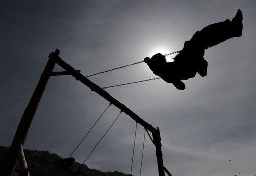 A girl swings at a park in Berlin
